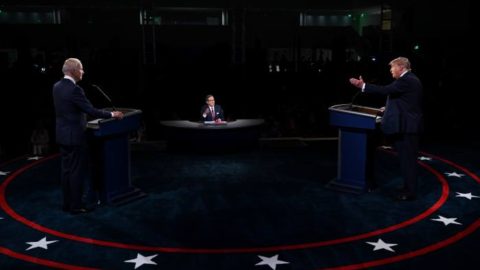 First Presidential Debate between Biden and Trump, each standing on opposite sides of the stage with a podium.