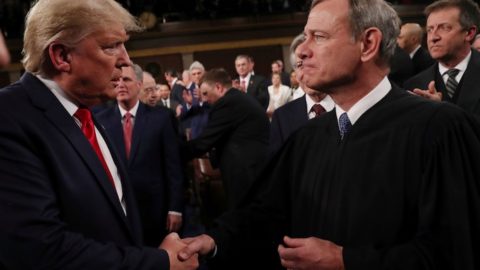 Donald Trump shaking hands with Chief Justice John Roberts