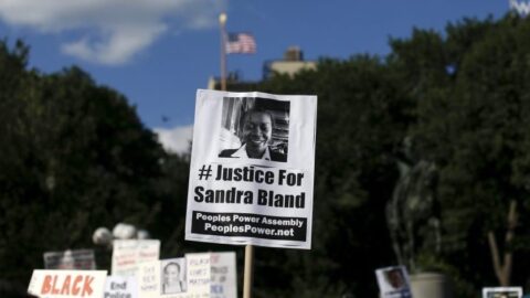Protest image of a sign, reading #JusticeForSandraBland