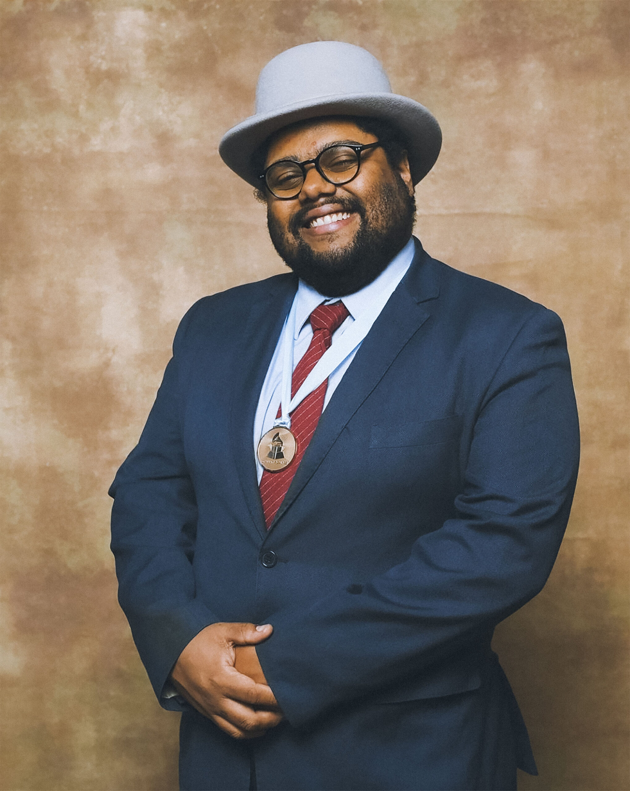 Portrait of Colin Hancock wearing suit and hat