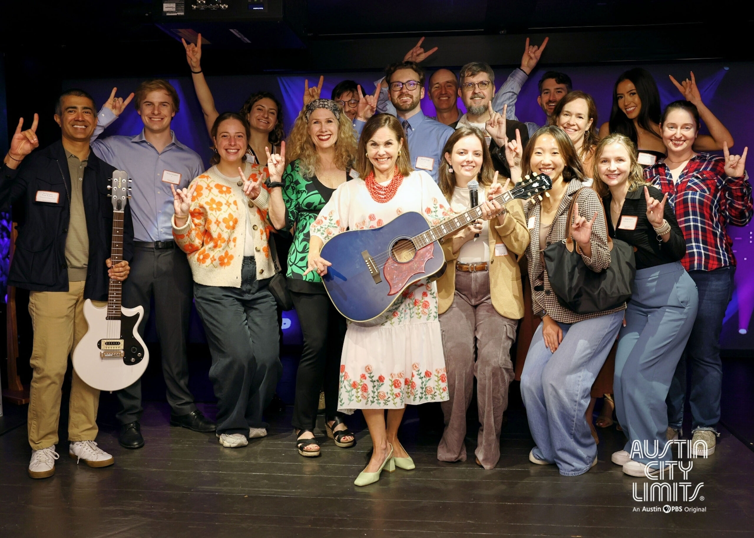 Photo of Rémi Ratliff (center) with group of alumni mentors and student mentees at Austin City Limits.