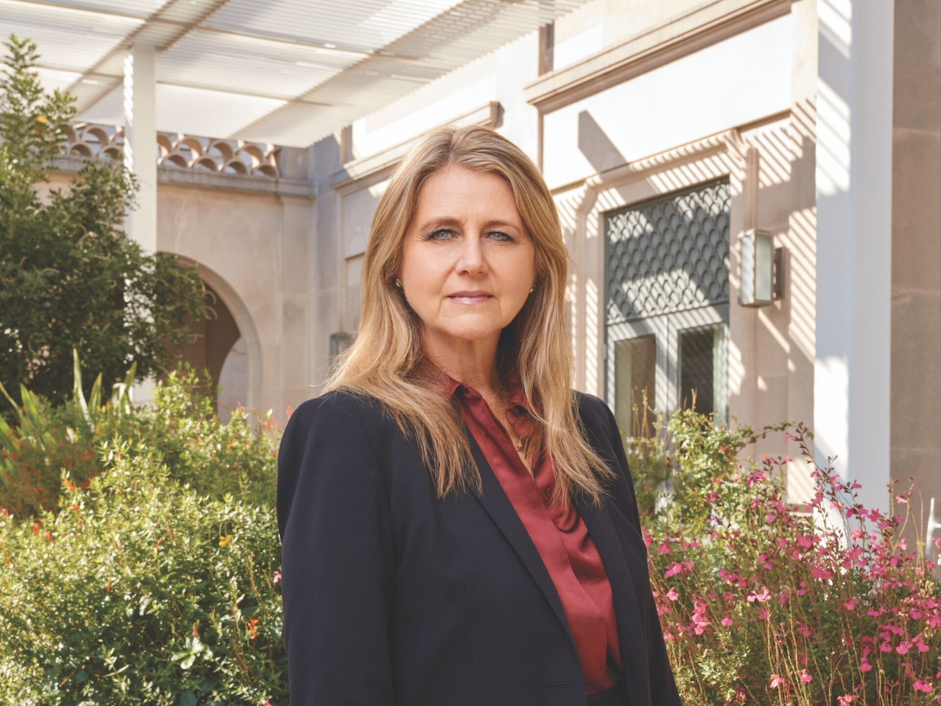 Mindy Montford outside of the Texas Law building with greenery