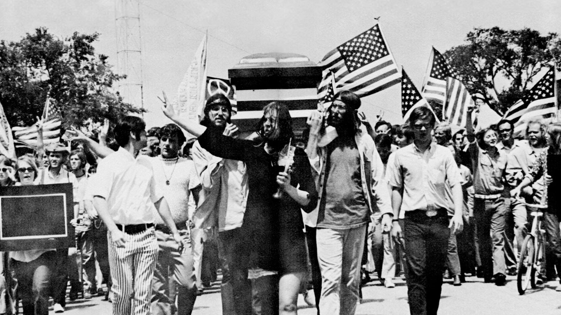 University of Texas students march in Austin, TX, during a Vietnam War protest, carrying a flag-draped coffin in a peaceful demonstration, May 1970.