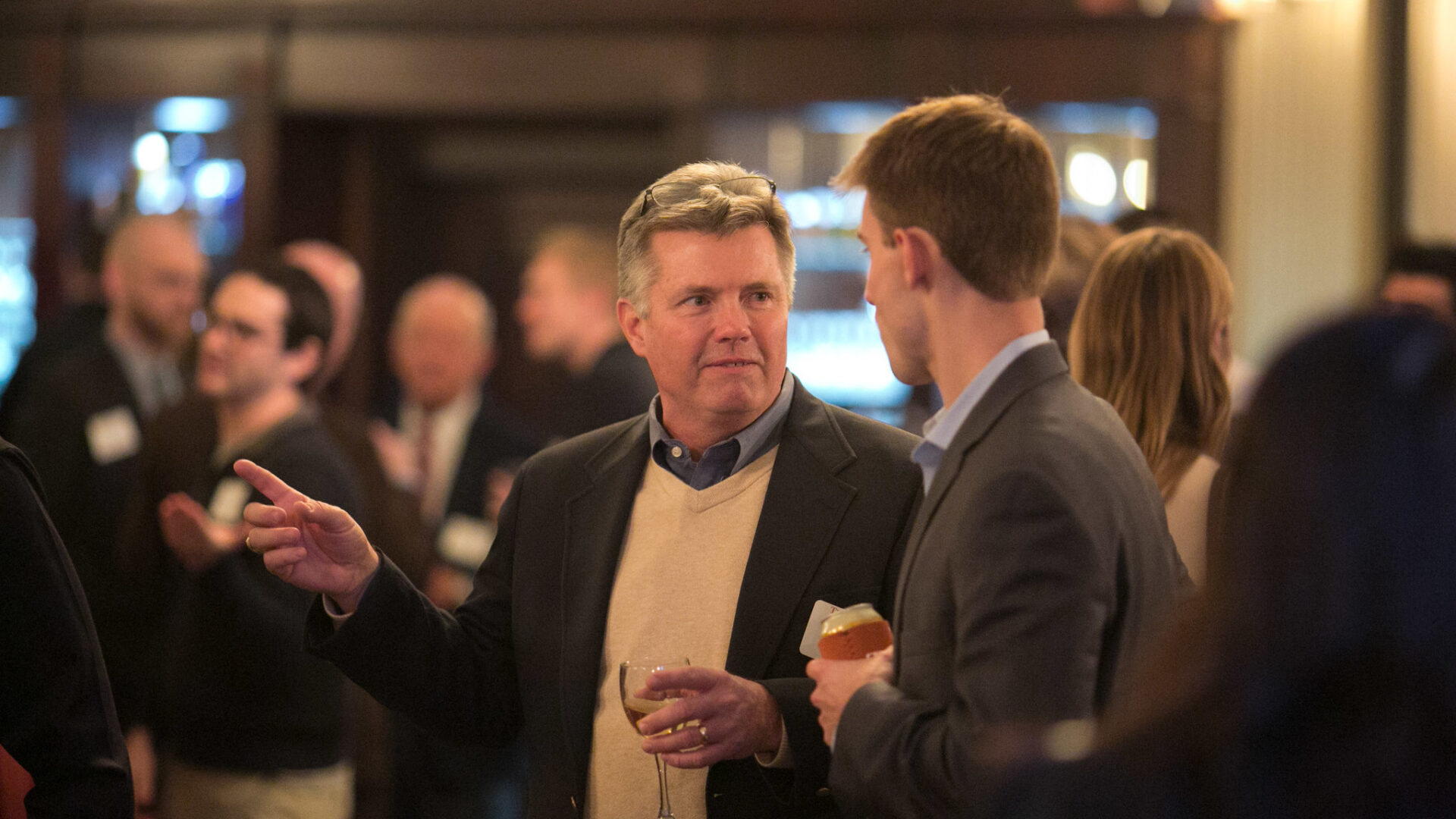 austin alumni association members chatting