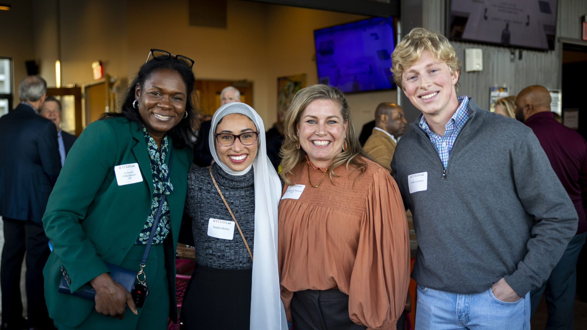 A photo of four alumni at a Texas Law on Tour event.