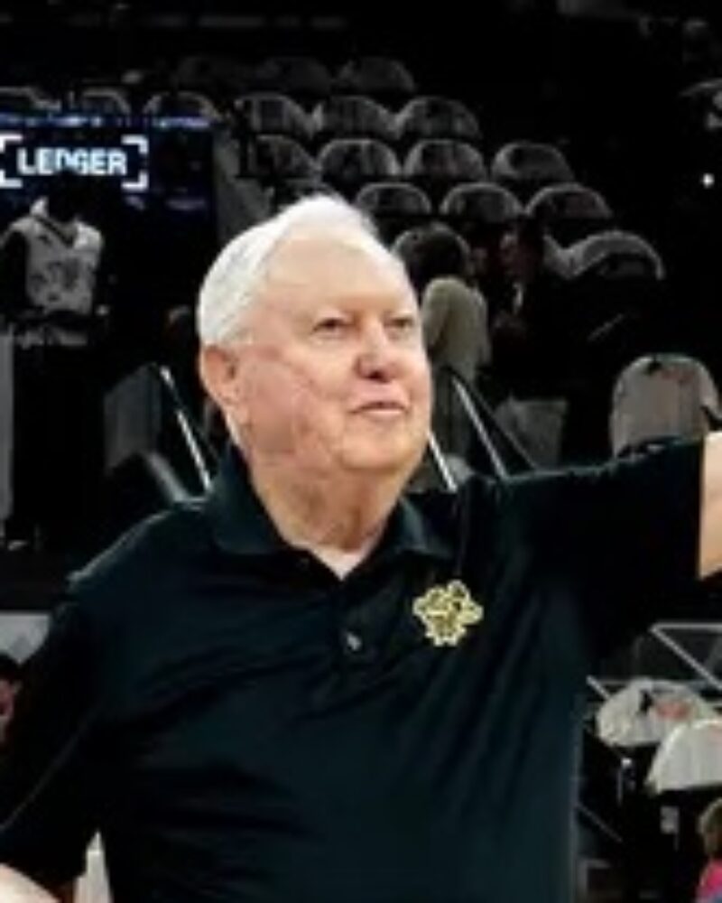 Photograph of Art Bayern receiving a framed jersey from the San Antonio Spurs