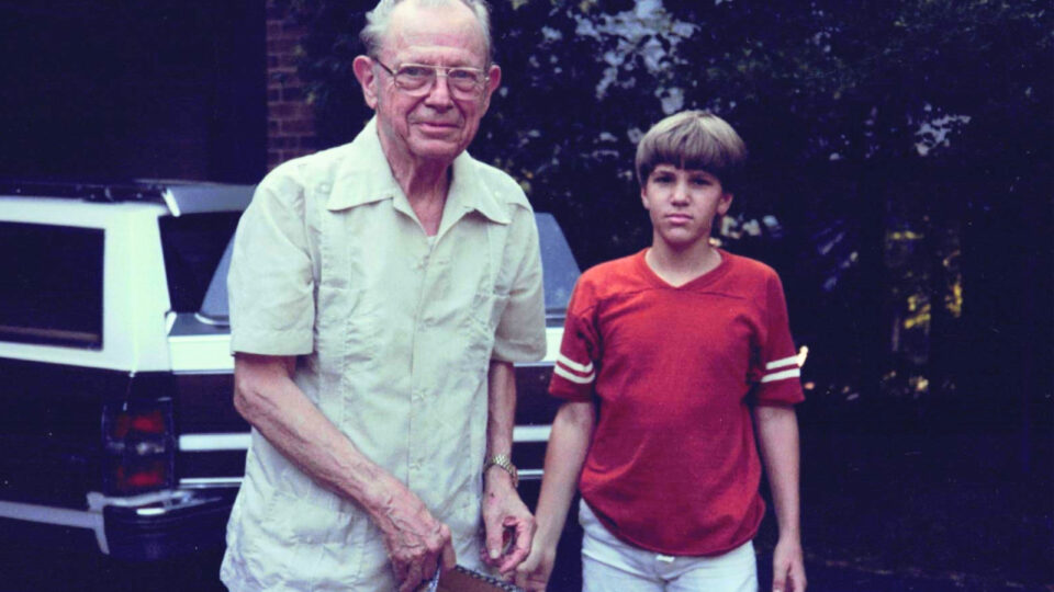 John Keeton and his grandfather Dean Keeton standing by a car