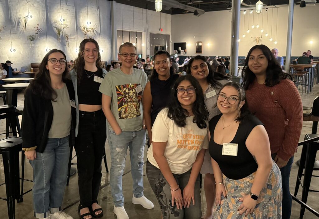 A photo of a group of people posing and smiling together at our RJ community happy hour