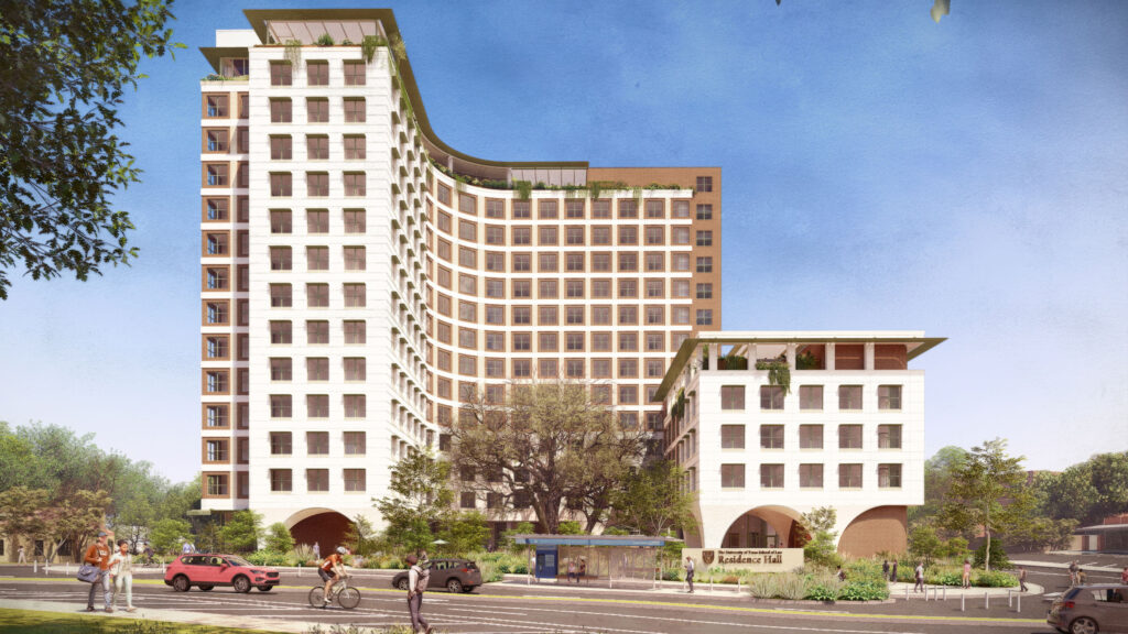 Wide exterior view of the residence hall from across the street on Dean Keeton. The curved multi-story building has a green rooftop and arched ground-floor openings. Students walk and bike along the sidewalk in the foreground.