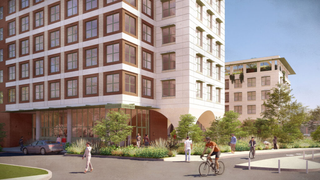 Street-level view of the base of the residence hall on Dean Keeton and Hampton with a café at ground level. Pedestrians walk along a landscaped path and a cyclist rides by in the foreground.