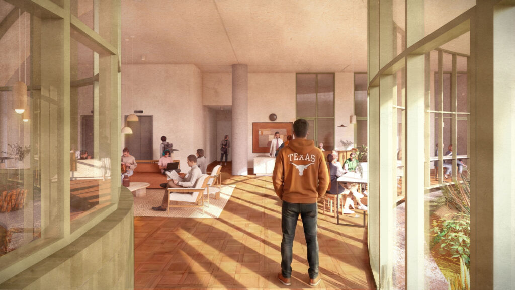 A student stands in a doorway looking into a large, open lobby. Students sit in chairs and on sofas and study at tables inside.