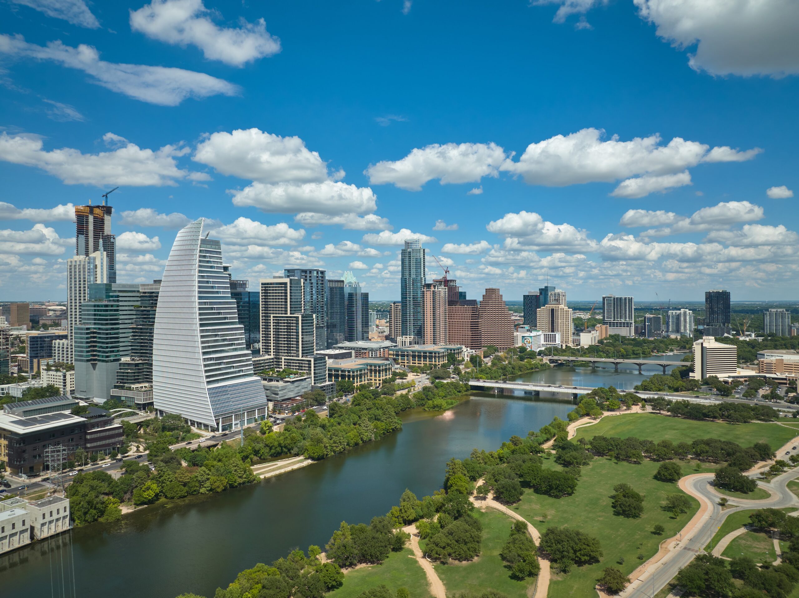 The Austin skyline, seen from south of the Colorado River, looking northeast to the First Street and Congress Avenue bridges.